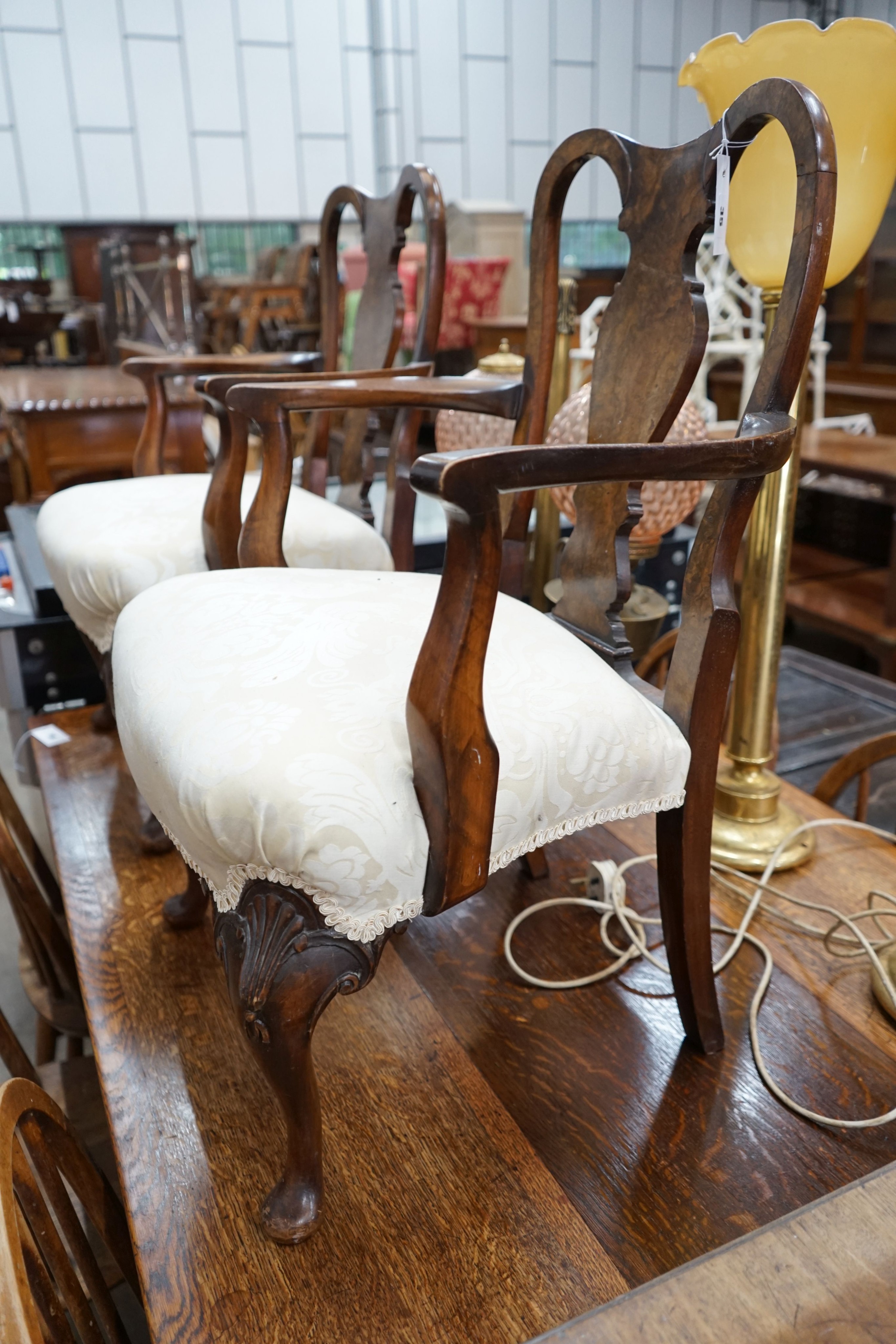 A pair of Queen Anne revival walnut child's elbow chairs, width 50cm, depth 42cm, height 79cm